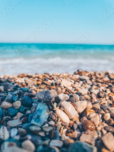 pebbles on the shore against the backdrop of a blue beautiful ocean