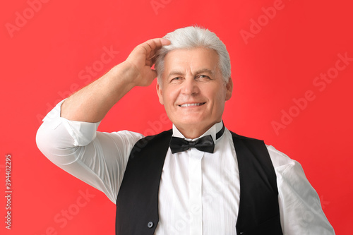 Stylish senior man on color...
