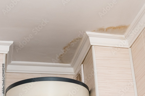 Photography Neighbors have a water leak, water-damaged ceiling, close-up of a stain on the c