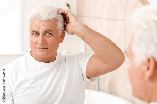 Senior man with grey hair n...
