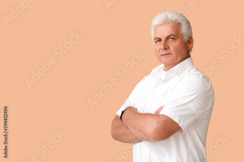 Stylish senior man on color...