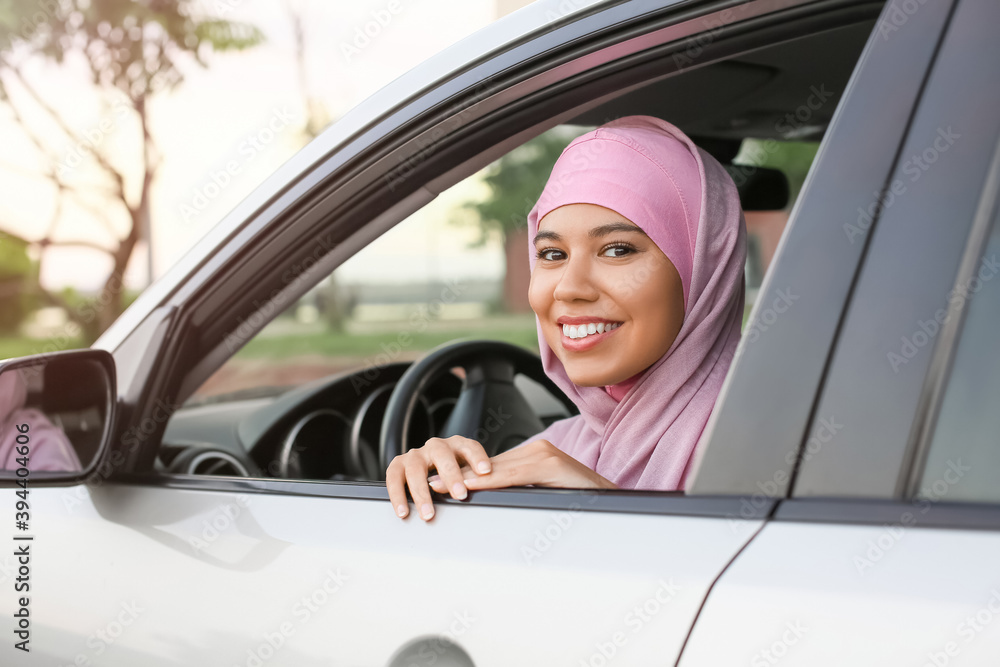 Young Muslim woman sitting in car Young Muslim woman sitting in car