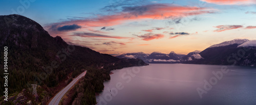 Sea to Sky Hwy in Howe Sound near Squamish, British Columbia, Canada. Aerial panoramic View. Dramatic Colorful Sunset Sky Art Render.