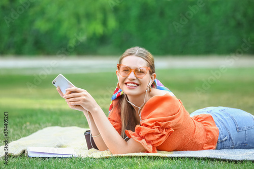 Beautiful young woman liste...