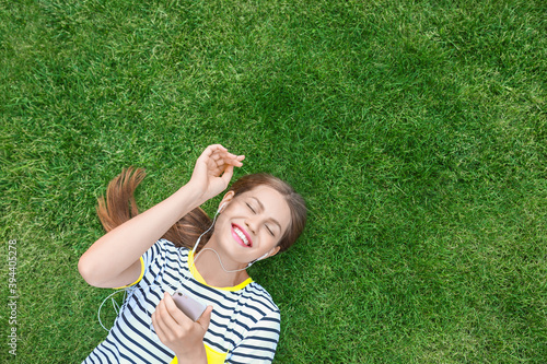 Beautiful young woman liste...