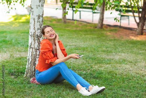 Beautiful young woman liste...