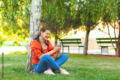 Beautiful young woman liste...