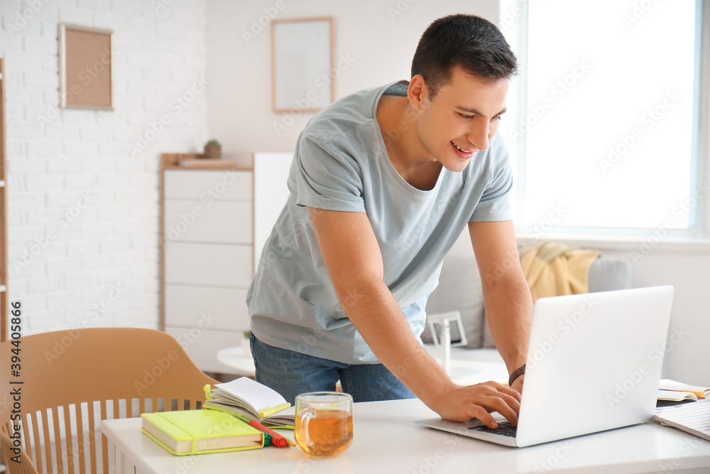 Young man working on laptop in office Young man working on laptop in office