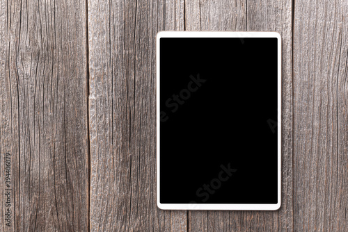 White tablet pc on a wooden background