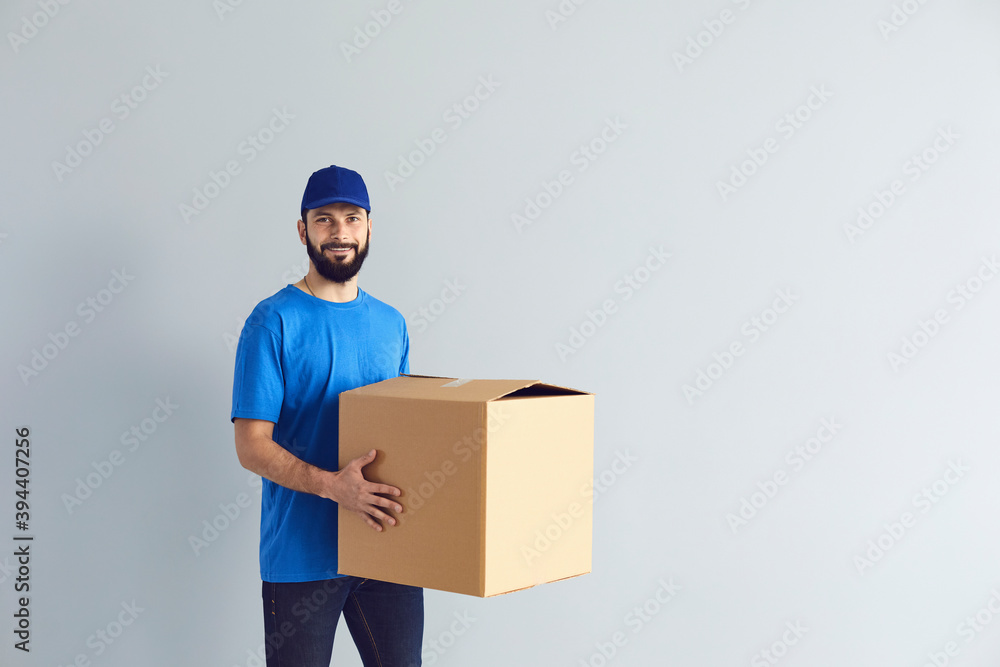 Happy male courier smiling for camera Happy male courier smiling for camera