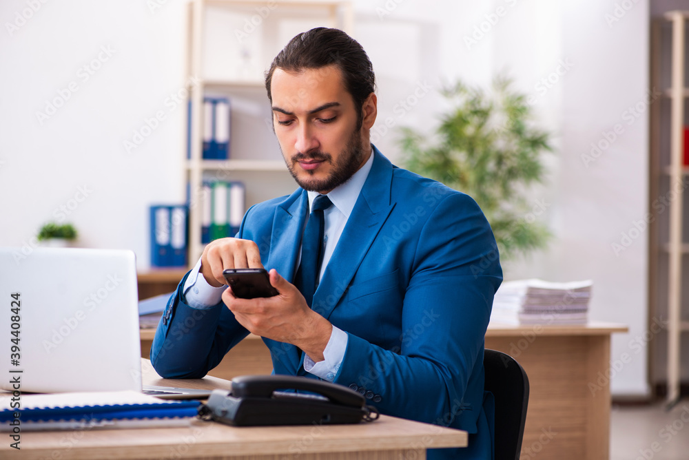 Young male employee and too many work in the office Young male employee and too many work in the office
