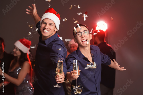 Young men celebrating New Year in night club
