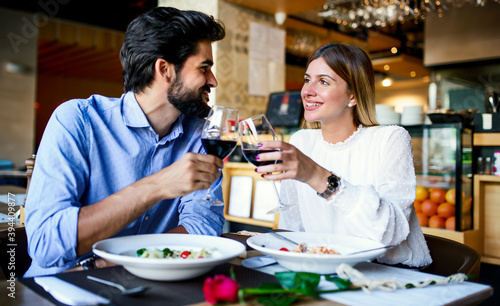 Paste and red wine. Young couple enjoying lunch in the restaurant. Lifestyle, love, relationships, food concept © bobex73