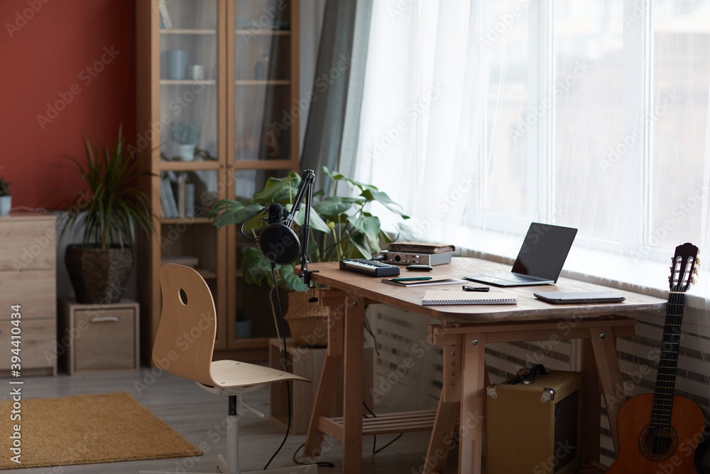 Fototapeta premium Background image of inviting home recording studio with music equipment and guitar, copy space