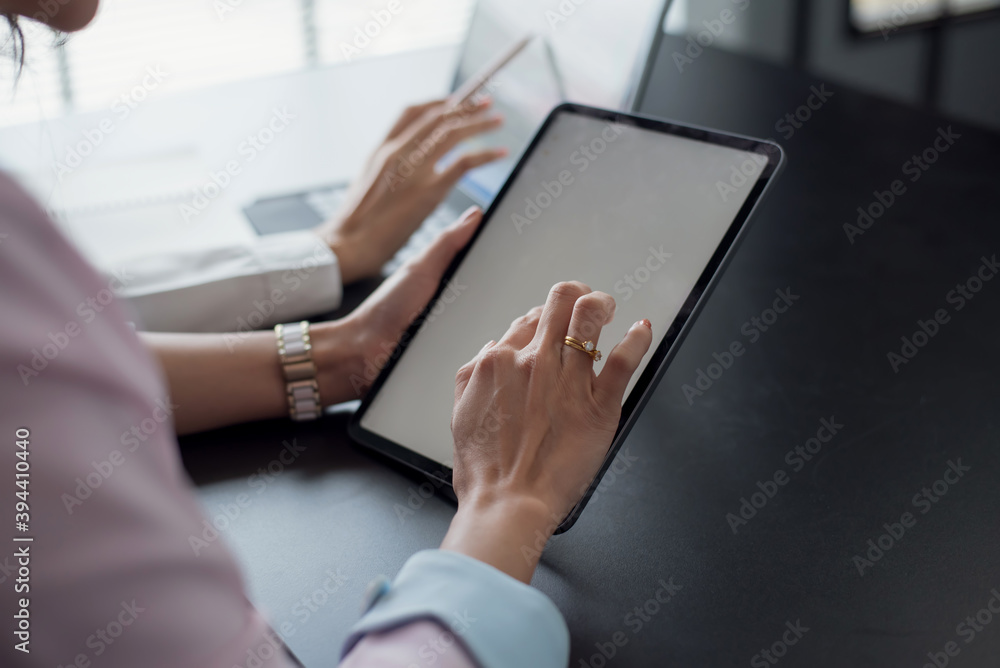 Fototapeta premium Close up. two businesswoman using digital tablet at meeting.