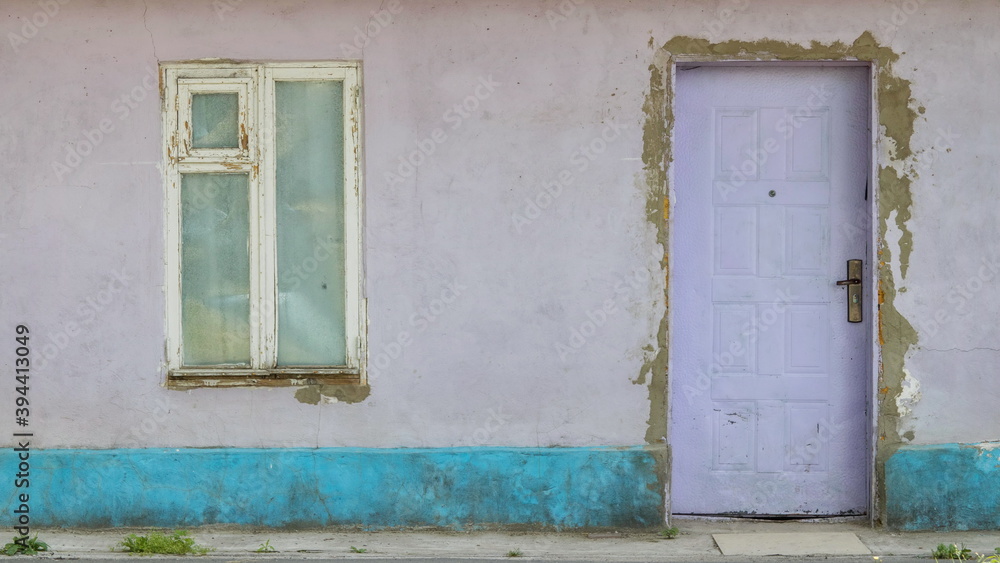 A fragment of a house from the early twentieth century, a wall with a window and a door made in the Estonian style A fragment of a house from the early twentieth century, a wall with a window and a door made in the Estonian style