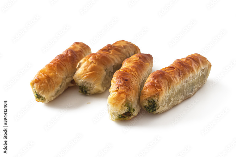 Rolled puff pastry rolls with green spinach and cheese on white