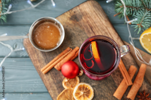 Glass cup of tasty mulled wine on table
