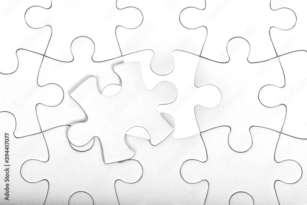 White jigsaw puzzle pattern background. placing last piece of jigsaw puzzle White jigsaw puzzle pattern background. placing last piece of jigsaw puzzle