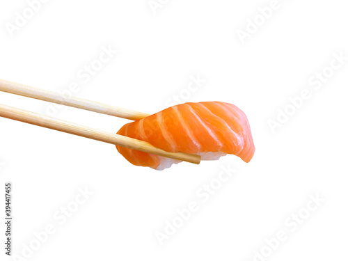 Bamboo chopsticks are holding nigiri sushi with salmon isolated on white background, Japanese food, Copy space for text. Clipping path..