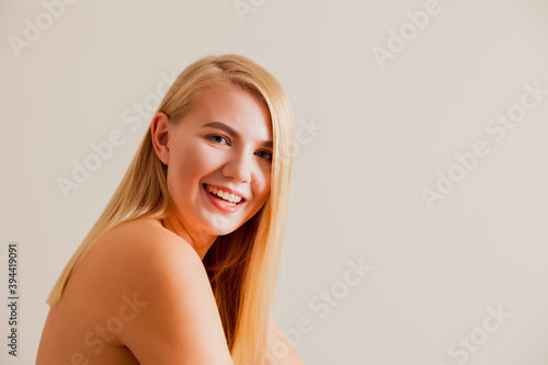 The young female model with bare shoulder is posing at the camera