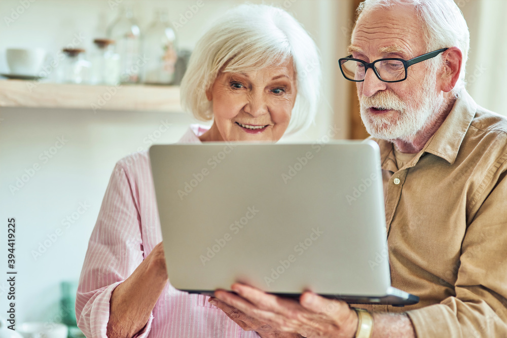 Senior man and woman using laptop together