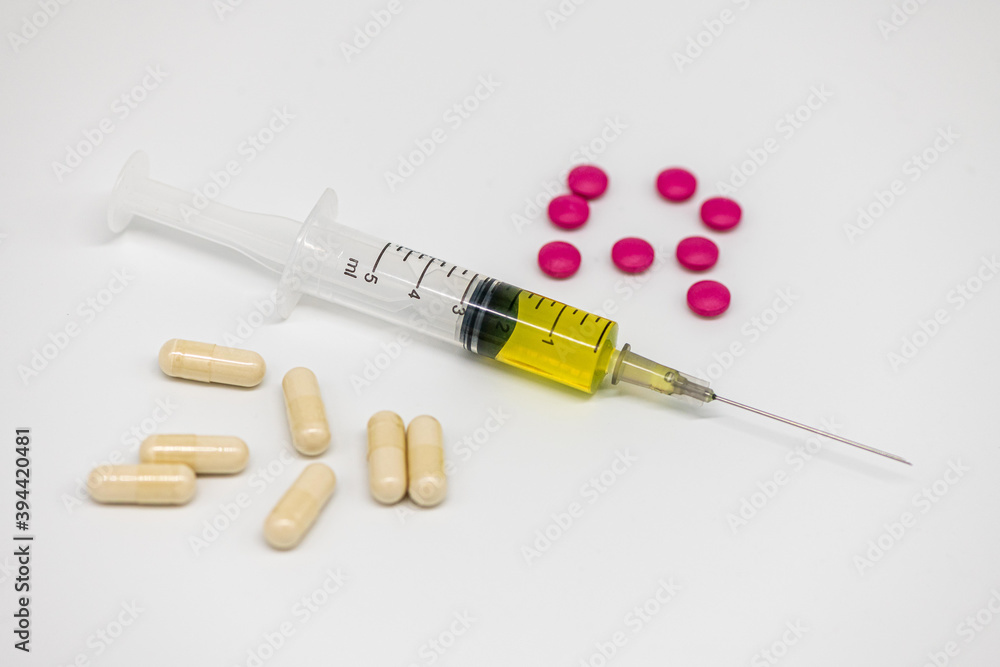 different pills syringe on a light background large different pills syringe on a light background large