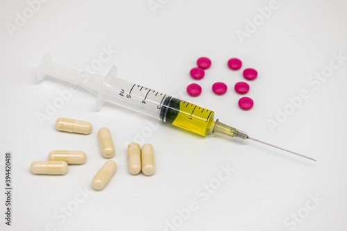 different pills syringe on a light background large