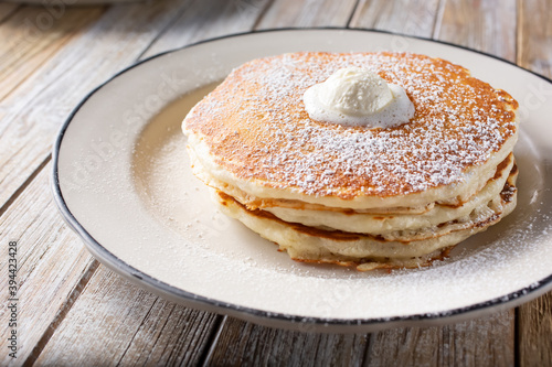 Tablou pe pânză A view of a plate of pancakes, topped with a mound of whipped butter