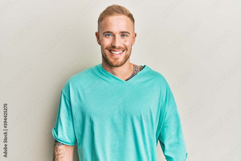 Young caucasian man wearing casual clothes with a happy and cool smile on face. lucky person. Young caucasian man wearing casual clothes with a happy and cool smile on face. lucky person.