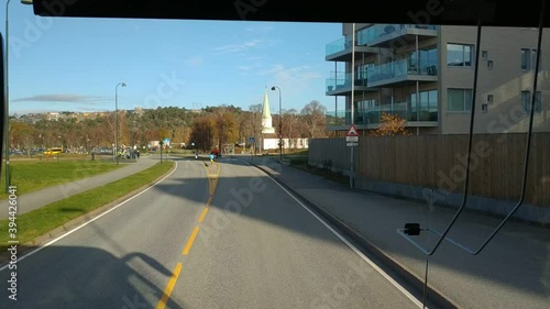 View on the road from the bus near Kristiansand, Norway at sunny autumn weather