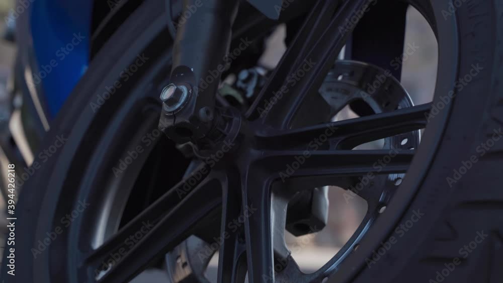 Front motorcycle wheel, brake calipers, brake disc, cloudy Front motorcycle wheel, brake calipers, brake disc, cloudy