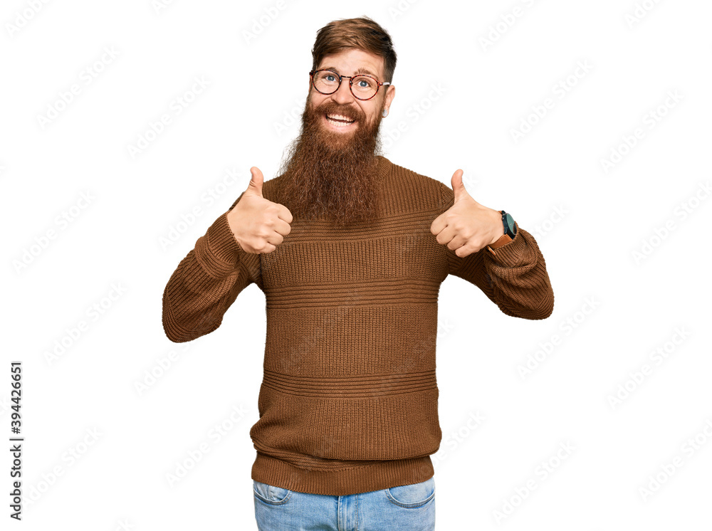 Young irish redhead man wearing casual clothes and glasses success sign doing positive gesture with hand, thumbs up smiling and happy. cheerful expression and winner gesture. Young irish redhead man wearing casual clothes and glasses success sign doing positive gesture with hand, thumbs up smiling and happy. cheerful expression and winner gesture.