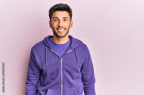 Young handsome man wearing casual sweatshirt with a happy and cool smile on face. lucky person. © Krakenimages.com