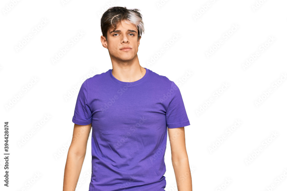 Young hispanic man wearing casual clothes with serious expression on face. simple and natural looking at the camera. Young hispanic man wearing casual clothes with serious expression on face. simple and natural looking at the camera.