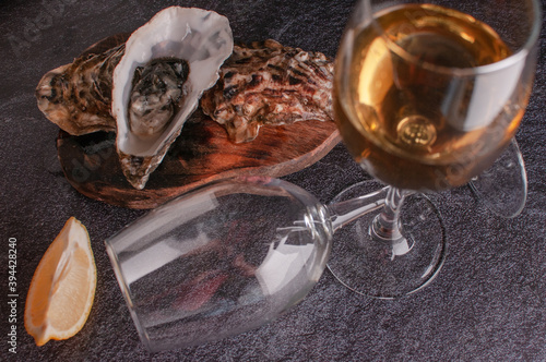 Oysters on the table with lemon and white wine