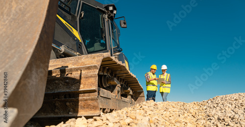 Workers discussing their job in quarry or gravel pit