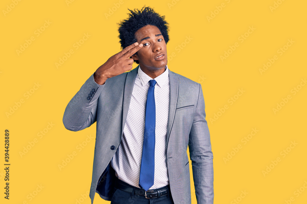 Handsome african american man with afro hair wearing business jacket shooting and killing oneself pointing hand and fingers to head like gun, suicide gesture. Handsome african american man with afro hair wearing business jacket shooting and killing oneself pointing hand and fingers to head like gun, suicide gesture.