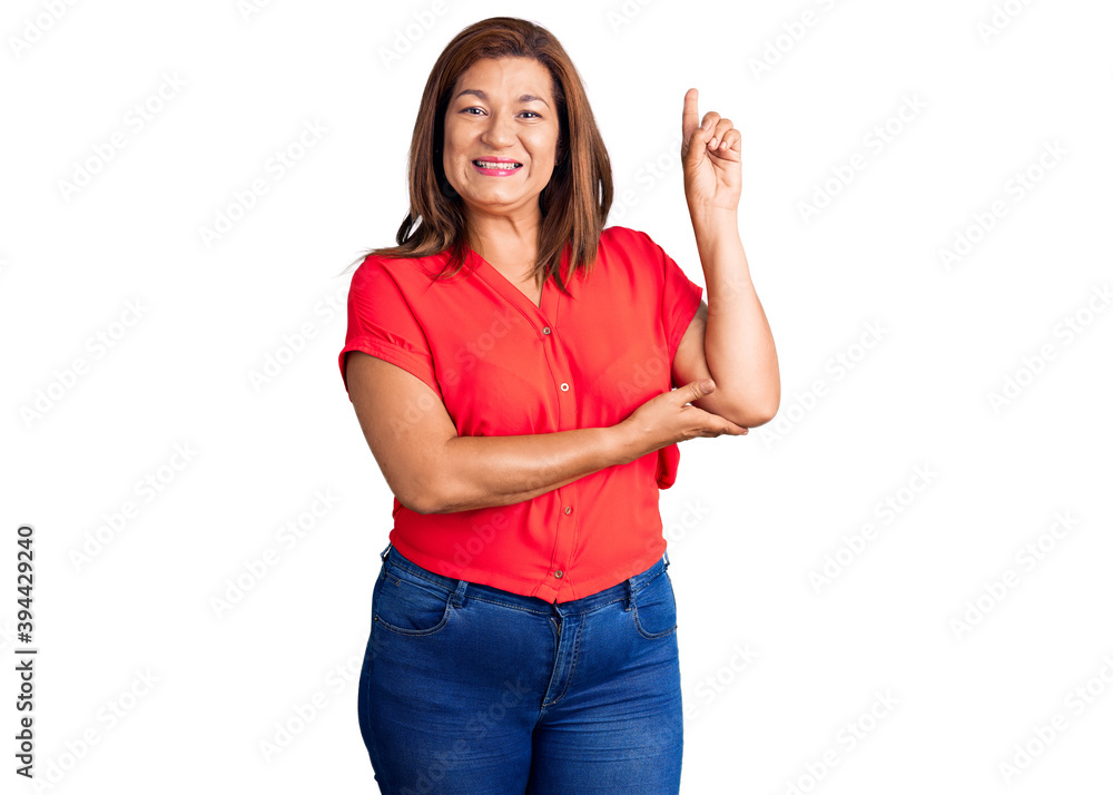 Middle age latin woman wearing casual clothes smiling happy pointing with hand and finger to the side Middle age latin woman wearing casual clothes smiling happy pointing with hand and finger to the side