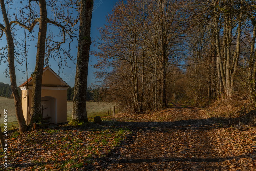 Chapel near path to Rybnik village with color sunrise light and frosty air Chapel near path to Rybnik village with color sunrise light and frosty air