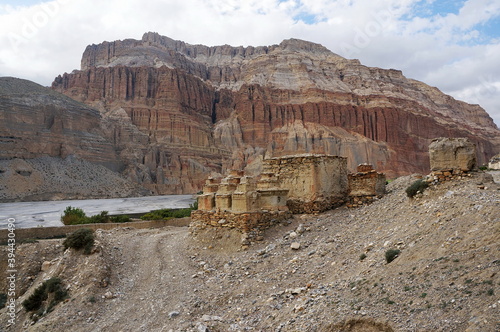 Buddhist chortens and ruins against the background of mountains, on the way to Chusang.  Upper Mustang. Nepal.