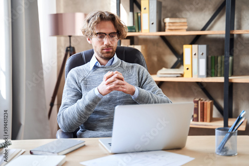 Businessman sitting at table with computer