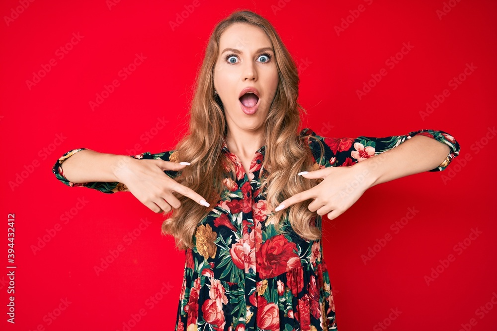 Young caucasian woman with blond hair pointing with fingers to herself afraid and shocked with surprise and amazed expression, fear and excited face.