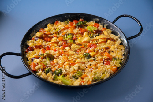 Traditional spanish paella with vegetables and chicken.