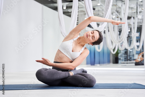 Woman practicing fitness with closed eyes