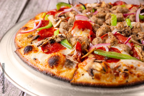 A closeup view of a supreme pizza.