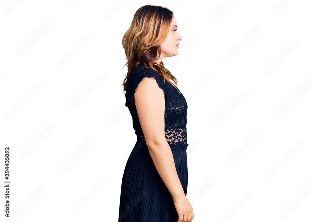 Young beautiful caucasian woman wearing elegant dress looking to side, relax profile pose with natural face with confident smile. Young beautiful caucasian woman wearing elegant dress looking to side, relax profile pose with natural face with confident smile.