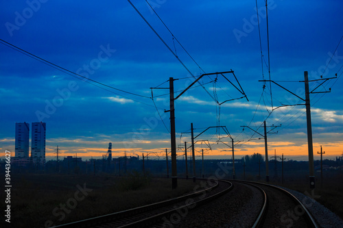 Railway line near the industrial zone at sunset or dawn