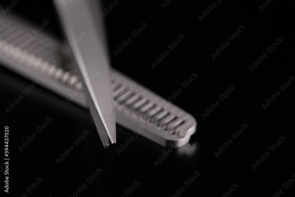 Barber scissors close-up. Scissor tips. A pair of scissors for cutting hair on a black background. Barber scissors close-up. Scissor tips. A pair of scissors for cutting hair on a black background.