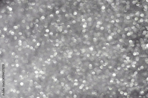 Christmas bokeh effect. Abstract texture of silvery color.